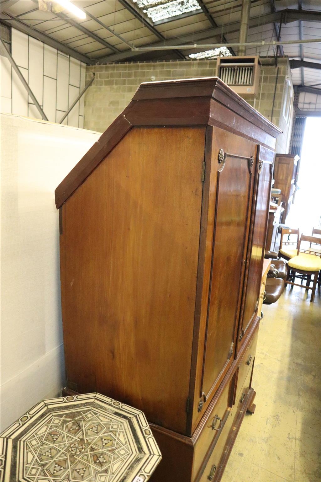 A Regency mahogany linen press, width 124cm, depth 60cm, height 192cm (top cut to fit eaves)